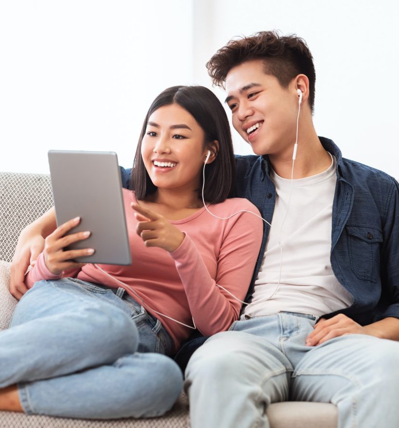 cheerful-asian-couple-using-digital-tablet-browsing-internet-at-home.jpg